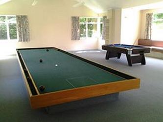 There is a large, separate games room with a pool table, table tennis, indoor bowls and more as well as lounge and table and chairs.